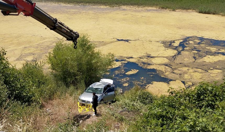 Sürücü kurtuldu, otomobil göletten vinçle çıkarıldı